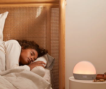 model seeping in a bed next to a nightstand where the hatch device is placed
