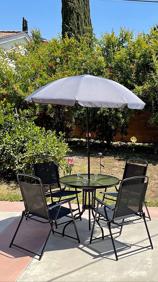 The table with four chairs and an umbrella
