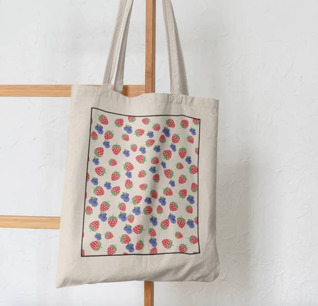 The tote bag with tiny strawberries and blueberries printing on it