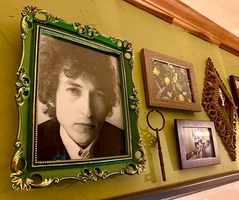 a reviewer photo of a gallery wall with the green frame hung up 