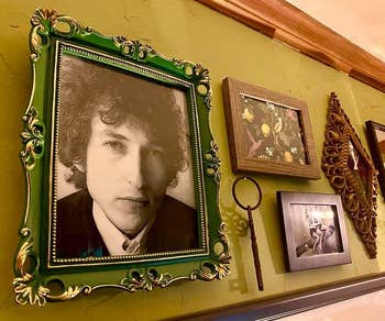 a reviewer photo of a gallery wall with the green frame hung up 