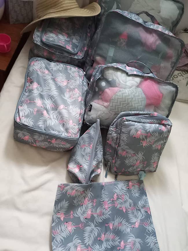 reviewer photo of their packing cubes, which have a flamingo pattern on them