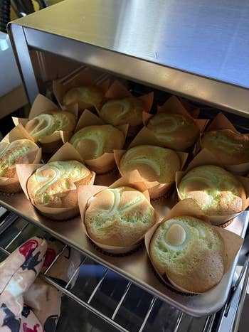 Freshly baked muffins successful  insubstantial  liners, cooling connected  a rack wrong  an oven