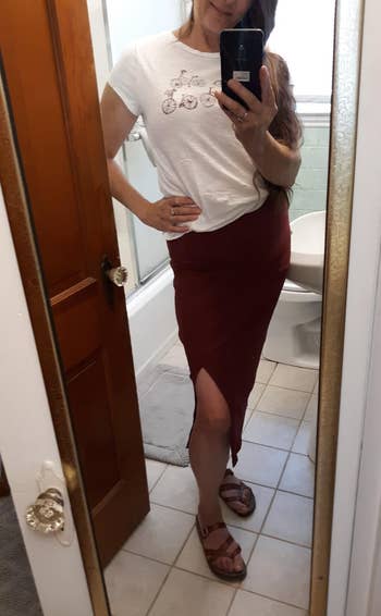 a reviewer wearing the skirt in dark red 