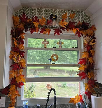Kitchen model adorned with autumn leaves, crosses, and decorative prima catchers. View extracurricular shows a grassy gait with scattered objects