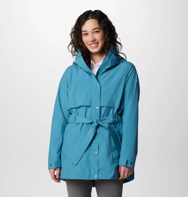 model wearing the raincoat in blue