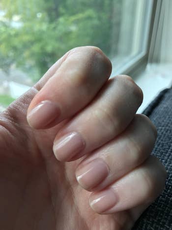 a reviewer with the polish on their nails