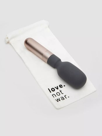 Vibrator on white storage bag with words 'love not war'