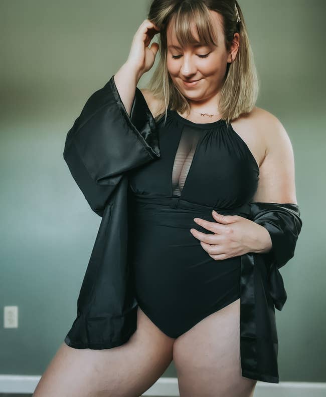 A reviewer in the swimsuit in black