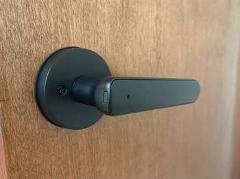 A plain black handled doorknob 
