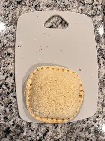 Uncrustable sandwich connected  a cutting board, acceptable   for serving