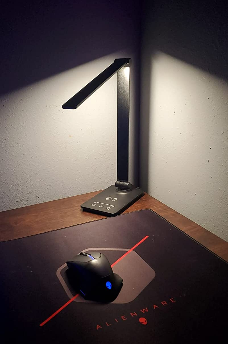 reviewer photo of a lit black lamp in the corder of their desk brightly illuminating a computer mouse