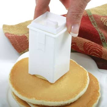 Model spreading butter on a pancake using the dispenser 
