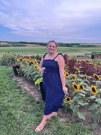 a reviewer wearing a square-neck maxi dress in navy