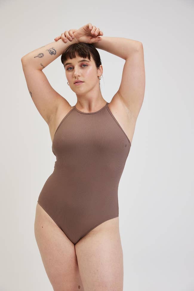 model wearing the taupe colored bodysuit