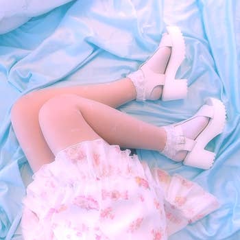 reviewer wearing the sandals successful  white