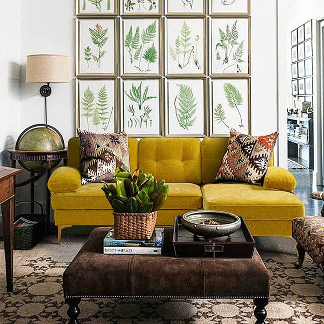 plush yellow asymmetrical sofa in maximalist living room 