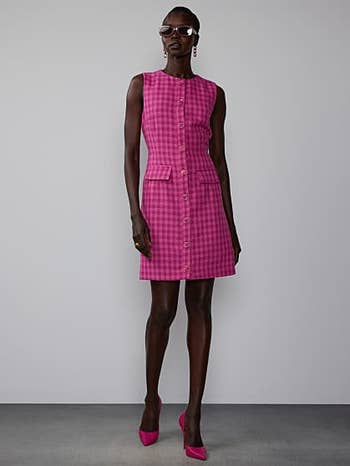 model in sleeveless button down pink check mini dress