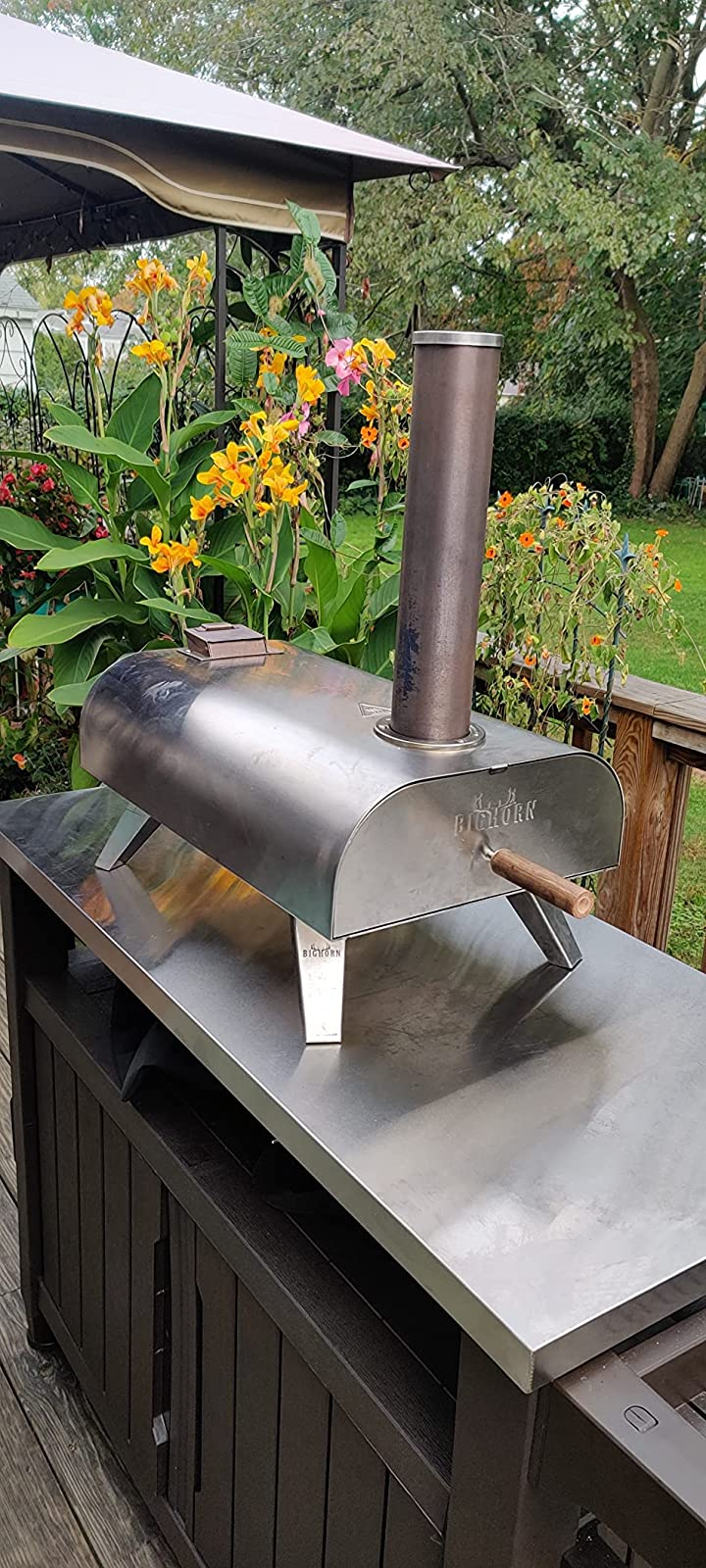 reviewer photograph  of the pizza oven connected  apical  of an outdoor table