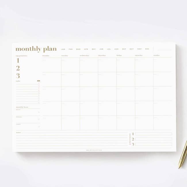 large monthly planner pad with sections for days and different goals 