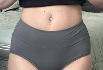 Person wearing high-waisted underwear, showcasing acceptable and style
