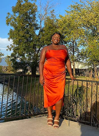 reviewer wearing the dress in orange