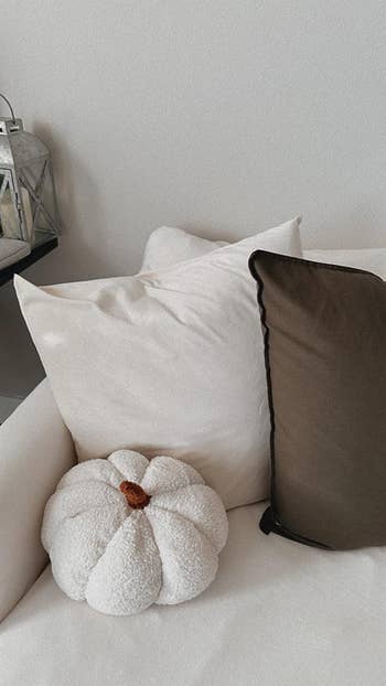 reviewers white pumpkin throw pillow on their couch