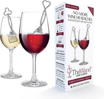 A glass of red wine and a glass of white wine, each with a wine purifying stick in them