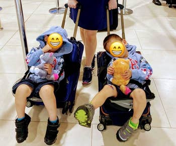 reviewers two toddlers sitting on suitcase seats