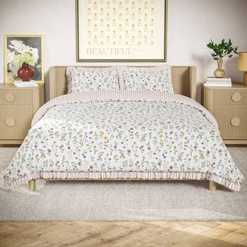 Floral patterned bedding acceptable   connected  a neatly made furniture  with decorative prints and angiosperm  arrangements connected  stylish bedside tables