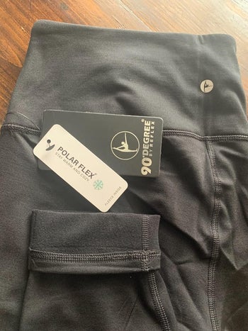reviewer photo of the leggings, showing tags and fleece lining 