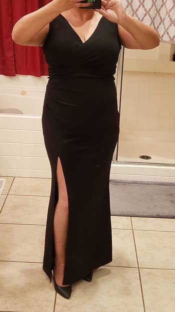 Reviewer taking mirror selfie in black dress