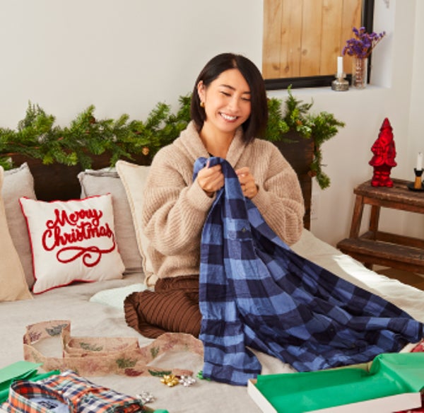Rie puts flannels into boxes lined with tissue paper