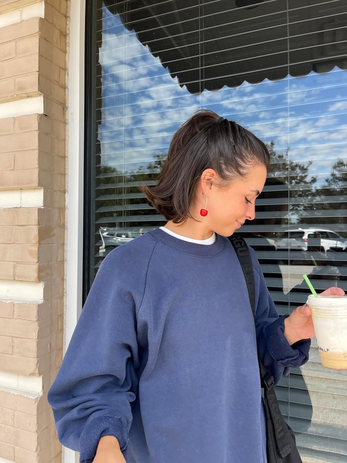 reviewer wearing cherry earring