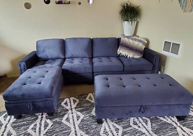 a reviewer photo of the navy blue couch and ottoman