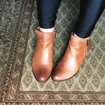 reviewer wearing toffee ankle booties