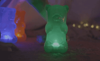 gif of the glowing green gummy bear shaped lamp