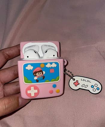 reviewer's AirPods in a super mario themed case