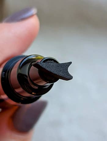 Reviewer's eyeliner pen with wing-shaped stamp