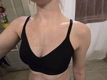 Person wearing a black, seamless, V-neck bra successful  a bath  setting