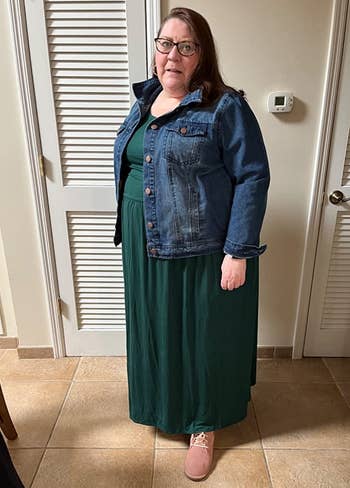 a reviewer wearing the same dress in green with a denim jacket over it