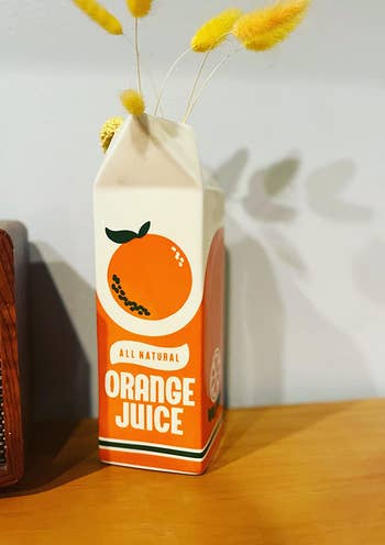the orange juice vase on a table