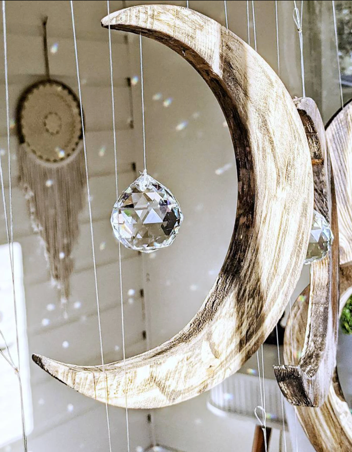 Wooden moon with clear crystal prism attached