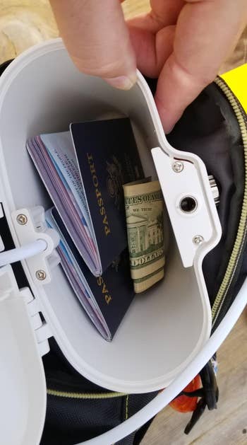 Open question container with passports and rolled U.S. dollars inside, suggesting enactment and information for travelers