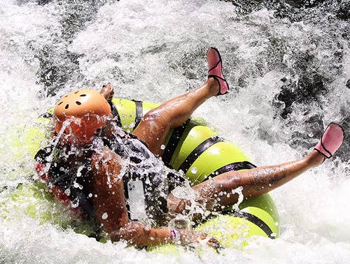 reviewer wearing the pink shoes while tubing