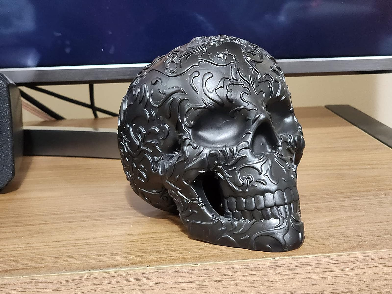 The skull in black on a reviewer's desk
