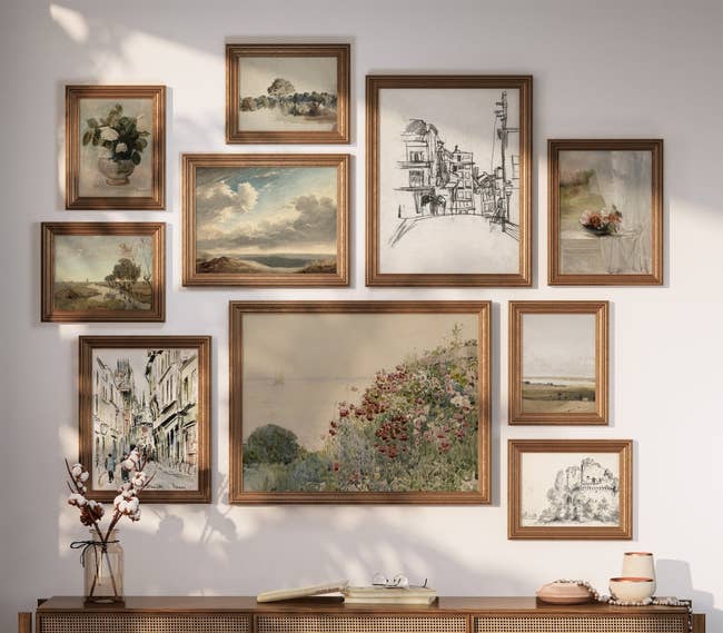 ten vintage-inspired art prints hanging on a gallery wallnin gold frames