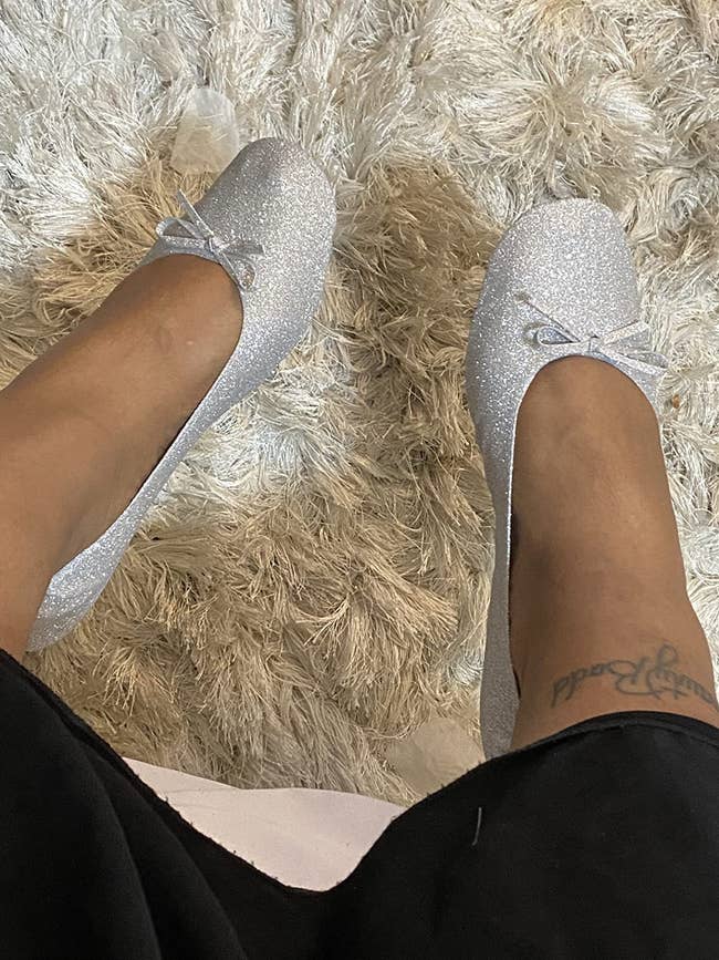reviewer wearing the flats in a sparkly silver color