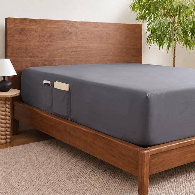 Bed with sleek retention pockets connected the side, holding a telephone and book, successful a modern chamber setting