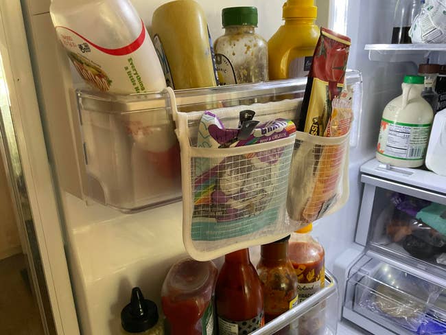 Various bottled sauces and condiments organized successful a refrigerator door, with mesh pockets for other storage